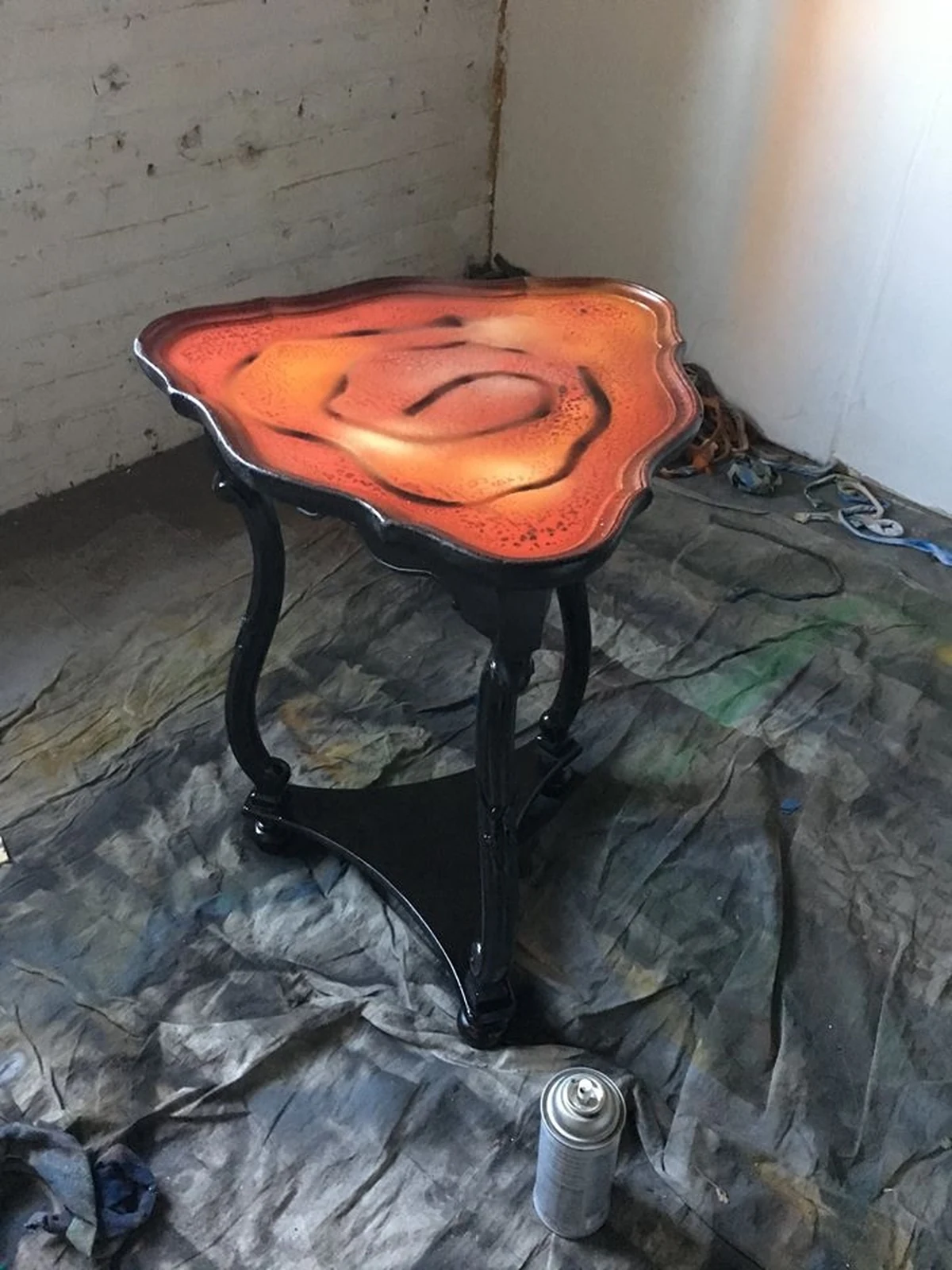 Hand-finished side table with an abstract orange resin top — studio piece by Jared Green